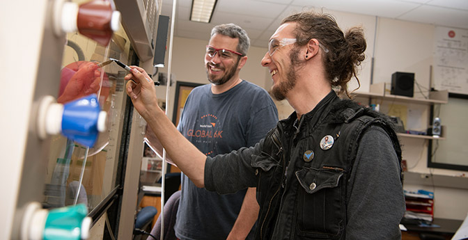 Professor and student at lab