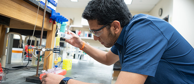 Student perfoming test with tubes